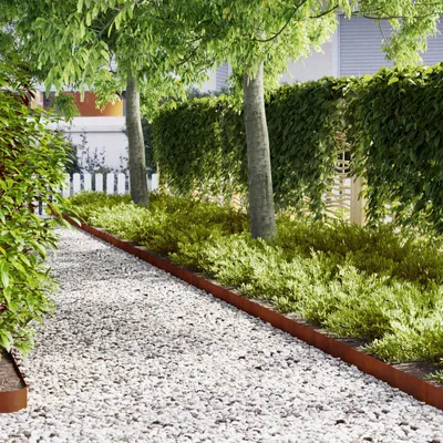 A garden path lined with white gravel and bordered by a rusty metal edge, leading past green bushes and trees.