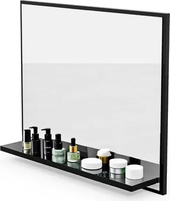 A black shelf with various cosmetic products displayed in front of a large mirror.