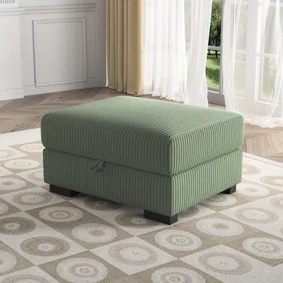 A green ottoman is placed on a patterned rug in a well-lit room with sheer curtains and a window in the background.