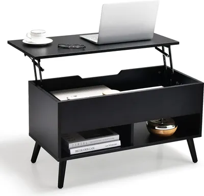 A black lift-top coffee table with a laptop, a cup of coffee, and glasses on its raised surface. The table has storage compartments below.