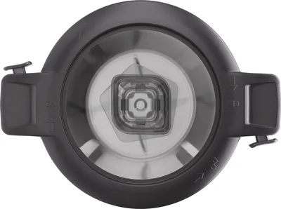 A top-down view of a blender attachment or mixing bowl with blades visible inside.