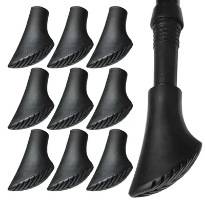 A collection of black rubber tips for trekking poles, with one pole tip shown attached to a pole.