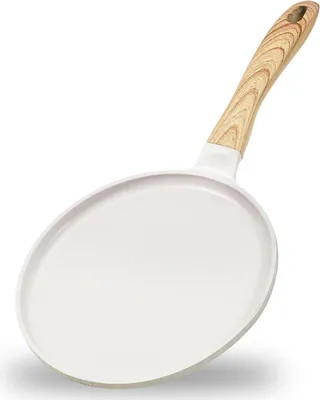 A white crepe pan with a wooden handle is shown against a white background.