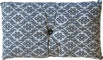 A rectangular cushion with a black and white floral pattern and a single button in the center.