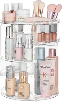A clear, well-lit studio shot of a rotating makeup organizer filled with various skincare and makeup products.