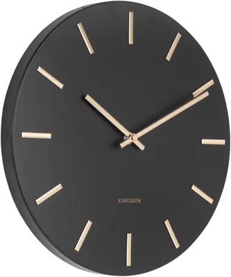 A black wall clock with gold hour markers and hands.