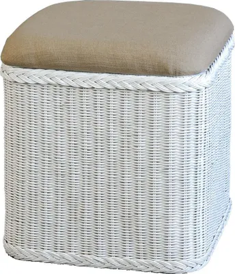 A white wicker storage ottoman with a tan upholstered top.
