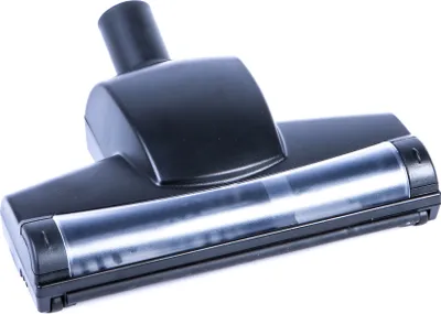 A black vacuum cleaner attachment with a clear plastic section is photographed against a white background.