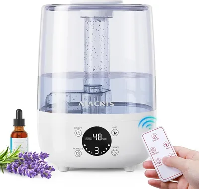 A humidifier with a bottle of essential oil and lavender flowers.