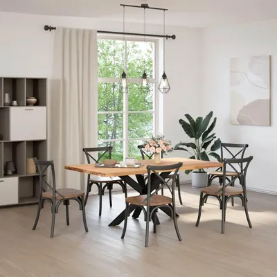 A dining room with a wooden table and chairs, a large window with greenery outside, and a bookshelf.