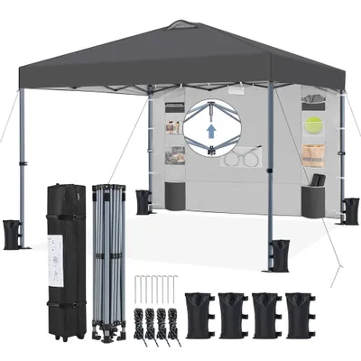 A gray pop-up canopy tent with its accessories laid out on a white background.