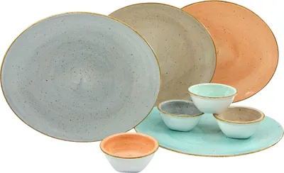 A collection of ceramic plates and bowls in various earthy tones.