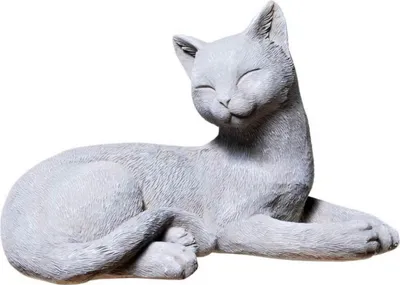 A gray statue of a cat lying down with its eyes closed.