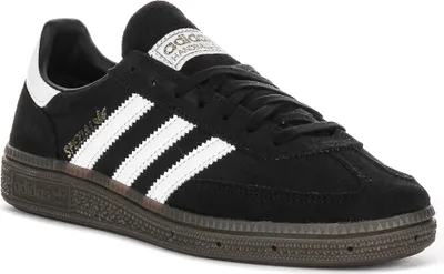 A black Adidas Handball Spezial J sneaker with white stripes and accents, shown from a side angle on a white background.