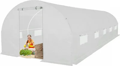 A woman is inside a white greenhouse, tending to plants.