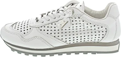 A side view of a white perforated sneaker.
