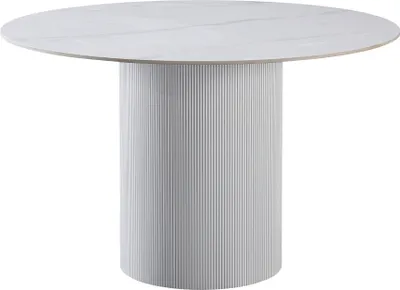 A round dining table with a fluted pedestal base.