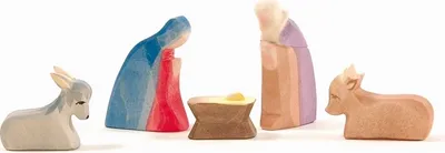 A nativity scene with wooden figures of Mary, Joseph, baby Jesus, a donkey, and a calf.