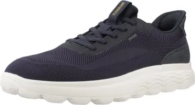 A single navy blue sneaker with a white sole is shown against a white background.