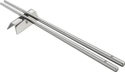 A pair of silver chopsticks resting on a silver chopstick rest.