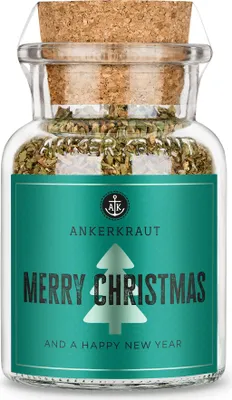 A glass jar filled with herbs, sealed with a cork and labeled for Christmas.