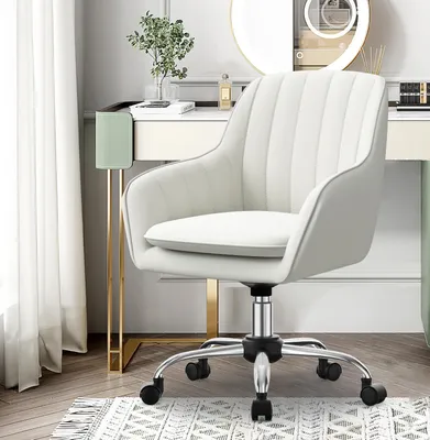 A white office chair is placed next to a vanity table with a mirror and some decorative items.