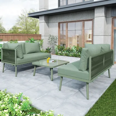 An outdoor patio scene with a green outdoor furniture set.