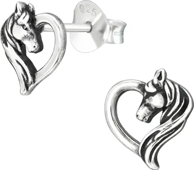 A pair of silver stud earrings shaped like a horse's head inside a heart.