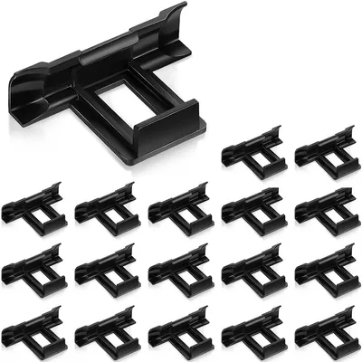 A collection of black plastic solar panel drainage clips arranged on a white background.