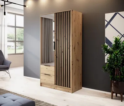 A modern bedroom or dressing room with a wardrobe, chair, and plant.
