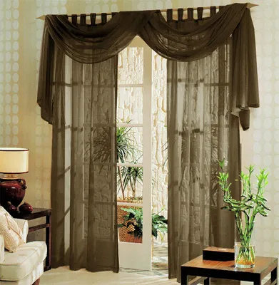 A set of brown voile curtains draped over a doorway, with a glimpse of an interior courtyard visible through the open door.