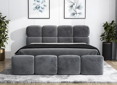 A modern bedroom setting with a gray upholstered bed.