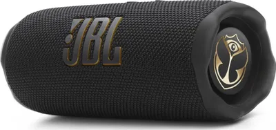 A black JBL speaker with gold accents, including the JBL logo and a Tomorrowland logo on one end.