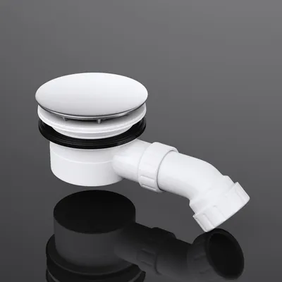 A white shower drain assembly with a silver cap and a white angled pipe is shown against a dark gray and black reflective background.