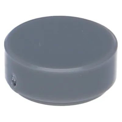 A single, dark gray, round LEGO tile is shown from a slightly elevated, diagonal angle against a light gray background.