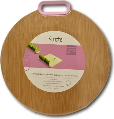 A round bamboo cutting board with a pink handle and a label showing product information and graphics.