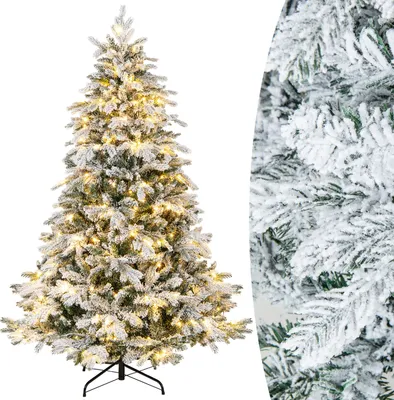 A flocked artificial Christmas tree with warm white lights.