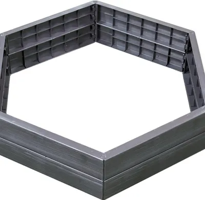 A hexagonal raised garden bed frame made of gray plastic.