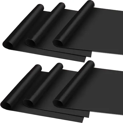 Two sets of rolled-up black grill mats are laid out on a white background.