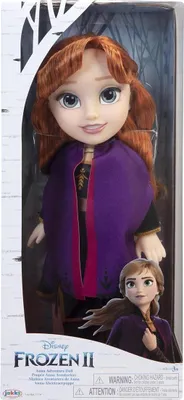 A doll in its packaging, with a smaller image of the doll on the box.