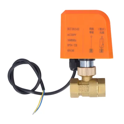 A close-up studio shot of an electric ball valve with an orange actuator and brass body, against a white background.
