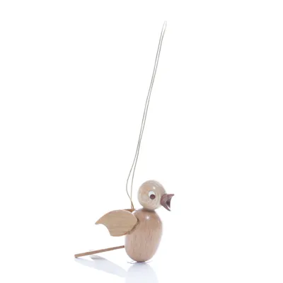 A small wooden bird ornament hanging from a string against a white background.