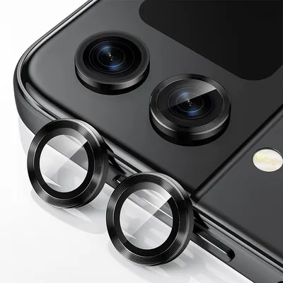 Close-up of camera lens protectors on a black smartphone.