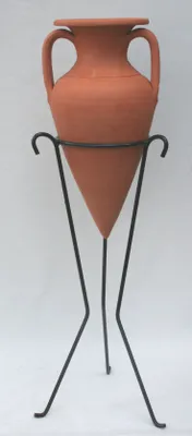 A terracotta amphora planter on a black metal stand against a white background.