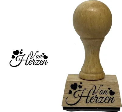 A wooden stamp with the text "Von Herzen" and hearts printed on it, shown next to a sample imprint of the stamp.