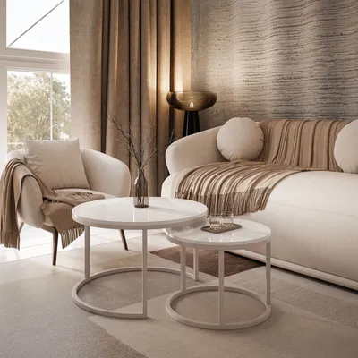 A modern living room scene with a sofa, armchair, coffee tables, and curtains.