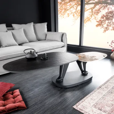 A modern living room with a sofa, coffee table, and large window.