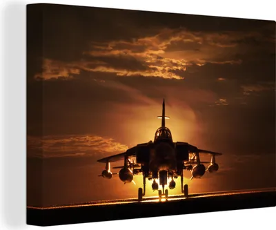 Produktbild von MuchoWow® - Leinwandbilder - Die Silhouette eines Kampfjets bei Sonnenuntergang, Wandbild, Wanddeko Bilder Wohnzimmer, 60x40 cm