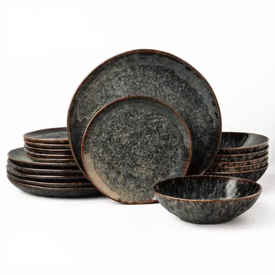 A set of modern, minimalist plates and bowls with a speckled gray and brown finish, arranged on a white background.