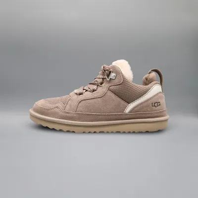 A single UGG shoe is shown against a plain gray background.